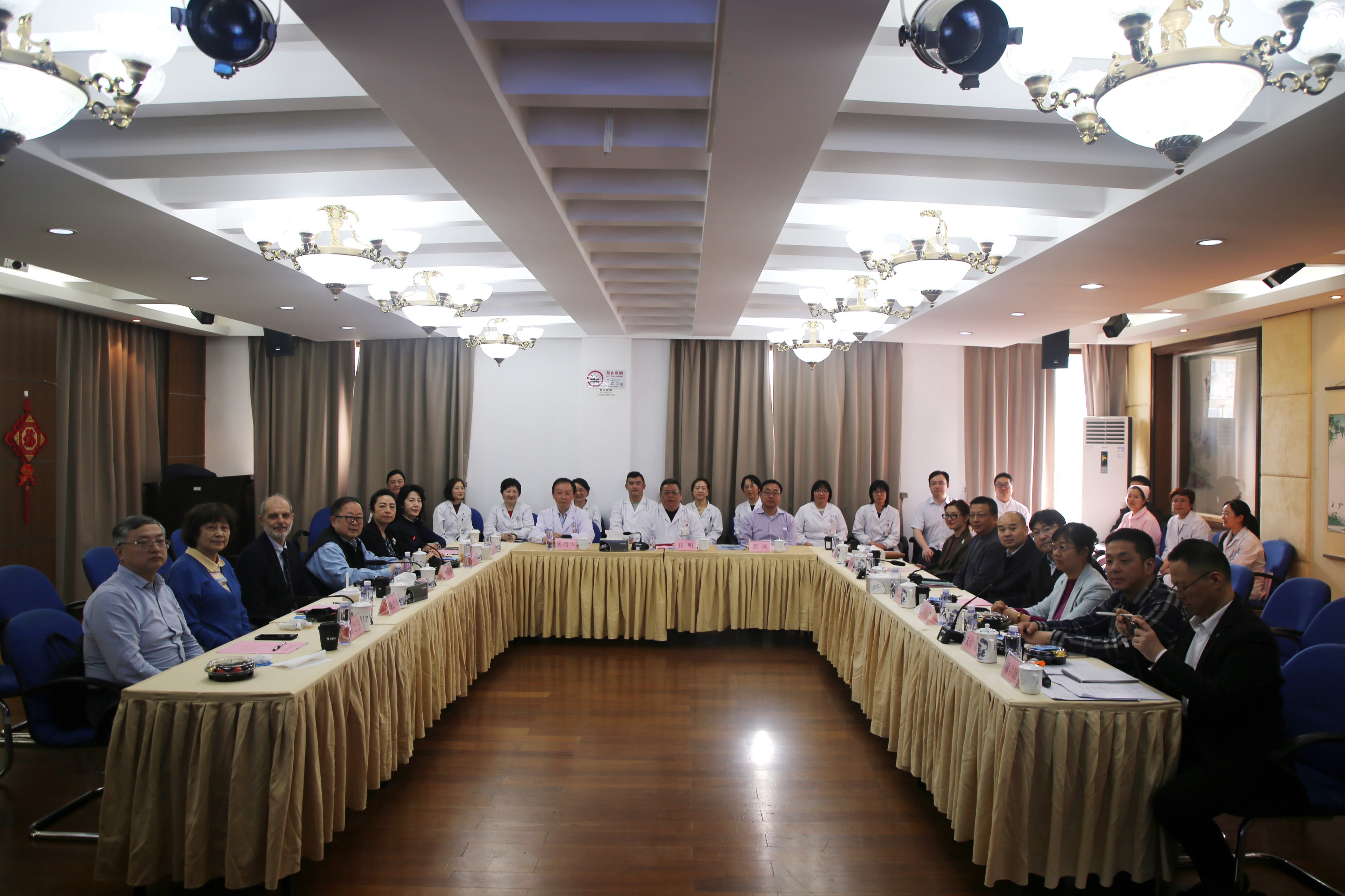 Assessment meeting at the Yinhang Community Health Service Centre with WONCA assessors, centre staff and local officials seated around a conference table